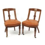 Pair of Victorian oak chairs with brown leather seats, 85cm high :For Further Condition Reports
