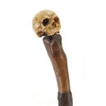 Naturalistic walking stick with carved bone pommel in the form of a human skull, 90.5cm in length :