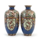 Pair of Japanese cloisonne vases enamelled with panels of birds of paradise and dragons, each 18.5cm
