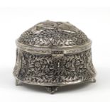 Large Indian silver coloured metal four footed jewel box, embossed with figures amongst flowers,