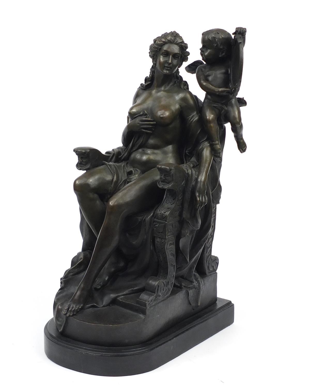 Large patinated bronze sculpture of a nude female in a throne with putti holding a mirror, raised on