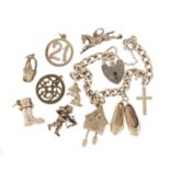 Silver charm bracelet with a selection of mostly silver charms including cuckoo clock, champagne
