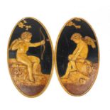 Pair of French oval classical plaster plaques of Cupid holding a bow, each 50cm x 25cm :For
