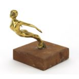 Art Deco car mascot of a nude female by Desmo, raised on a wood block base, the mascot 11cm high :