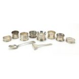 Silver items comprising seven silver napkin rings, Victorian spoon, baby's food pusher and a