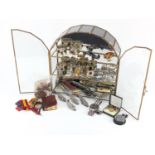 Collectables arranged in a mirrored glass display case including German clockwork bird, Corgi racing