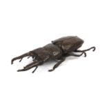 Japanese patinated bronze stag beetle with articulated wings, character marks to the underside, 13cm