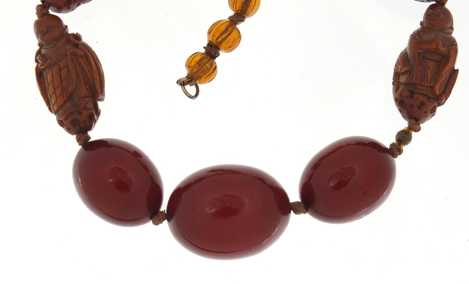 Chinese cherry amber coloured bead and carved coquilla nut necklace, 40cm in length :For Further - Image 2 of 4