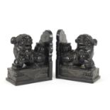 Pair of Chinese ebony carved stone dog-of-foo bookends, 16.5cm high :For Further Condition Reports