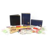 British and world stamps including Royal Mint presentation packs arranged in an album :For Further