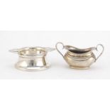 Circular silver tea strainer on stand and silver twin handled sugar bowl, Birmingham hallmarks,