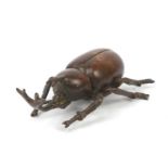 Japanese patinated bronze rhino beetle, impressed marks to the base, 7cm in length :For Further