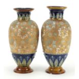 Two Doulton Lambeth stoneware vases, hand painted with flowers, numbered 9610 and 9980, each 30cm