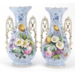 Pair of 19th century continental porcelain vases with twin handles, each hand painted with flowers
