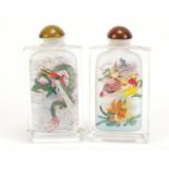 Two Chinese glass snuff bottles internally hand painted with dragons and fish, each 8.5cm high :