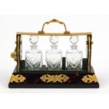 Boulle work style three bottle tantalus with a gilt metal mount, 26.5cm wide :For Further
