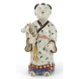 Chinese porcelain figure of a boy holding a toy horse hand painted with leaves, 20.5cm high :For