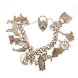 Silver charm bracelet with a selection of mostly silver charms including bulldog, rhino, classic car