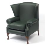 Contemporary wingback armchair with green leather button upholstery, 103cm high :For Further