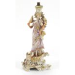 German porcelain figural candlestick encrusted with flowers by Plaue, numbered 576 75, 27.5cm