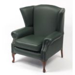 Contemporary wingback armchair with green leather button upholstery, 103cm high :For Further