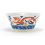 Chinese blue and white porcelain bowl, hand painted in iron red with dragons amongst clouds