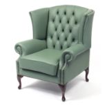 Contemporary wingback armchair with sage green leather buttonback upholstery, 103cm high :For