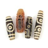 Three Tibetan agate beads and one other, the largest 6cm wide :For Further Condition Reports