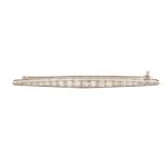 Good unmarked white metal graduated diamond bar brooch, 6.5cm in length, 4.7g, housed in a J