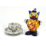 Continental floral encrusted porcelain cup with saucer and Murano glass clown, the largest 15cm high