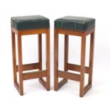 Two vintage walnut stools with green leather upholstered seats, 78cm high :For Further Condition