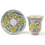 18th century Turkish Kutahya pottery cup and saucer hand painted with flowers, the cup 10cm high,