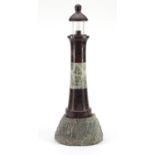 Large carved red serpentine marble lighthouse design lamp with rocky base, 56cm high :For Further