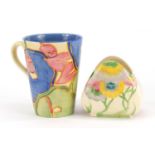 Art Deco Clarice Cliff pottery comprising a Blue Chintz mug and a Pink Pearls sugar bowl, the