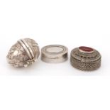 Three silver trinkets, one in the form of a bird's egg and one set with a cabochon carnelian