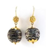 Pair of Islamic unmarked gold mounted glass earrings, hand painted with face masks, each 4.5cm in