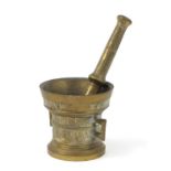 17th century style brass pestle and mortar, decorated with figures and flowers, the mortar 12cm high