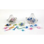 Collection of colourful Gozo glass sweets and two glass baskets, some sweets with paper labels,