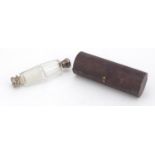 Victorian cut glass and unmarked silver double end scent bottle, housed in a leather case :For