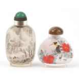Two Chinese glass snuff bottles internally hand painted with a winter landscape and birds amongst