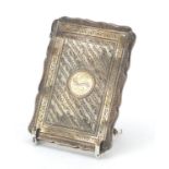 Victorian silver serpentine shaped card case, engraved with leaves and foliage, by Robert