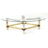 Brass coffee table with lozenge shape brass base having brown leather straps supporting a central