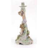 Large German porcelain Putti design candlestick encrusted with flowers by Plaue, 39cm high :For