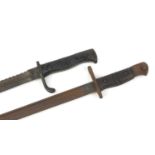 Two World War I bayonets comprising a Remington M1913 and sawback example, the largest 55.5cm in