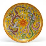 Chinese porcelain plate decorated with a dragon and phoenix amongst clouds, character marks to the