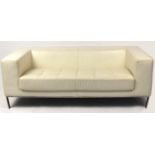 Contemporary cream leather two seater settee with chrome base, 65cm H x 180cm W x 86cm D :For