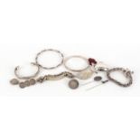 Silver and white metal jewellery including an identity bracelet and coin brooches, 211.0g :For