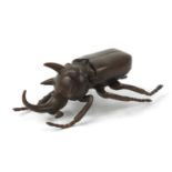 Large Japanese patinated bronze beetle with articulated wings, impressed character marks to the