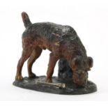 Novelty Austrian cold painted spelter table lighter in the form of a terrier beside a rock, 17cm