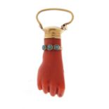 Victorian carved coral pendant in the form of a clutched hand with unmarked gold mounts and